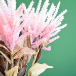 No centro, foco aproximado nas flores de astilbe rosa e branca com efeito envelhecido em fundo verde